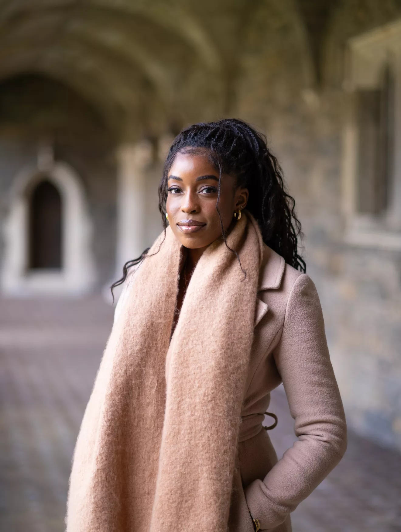 Toyo Aboderin standing in the Cloisters