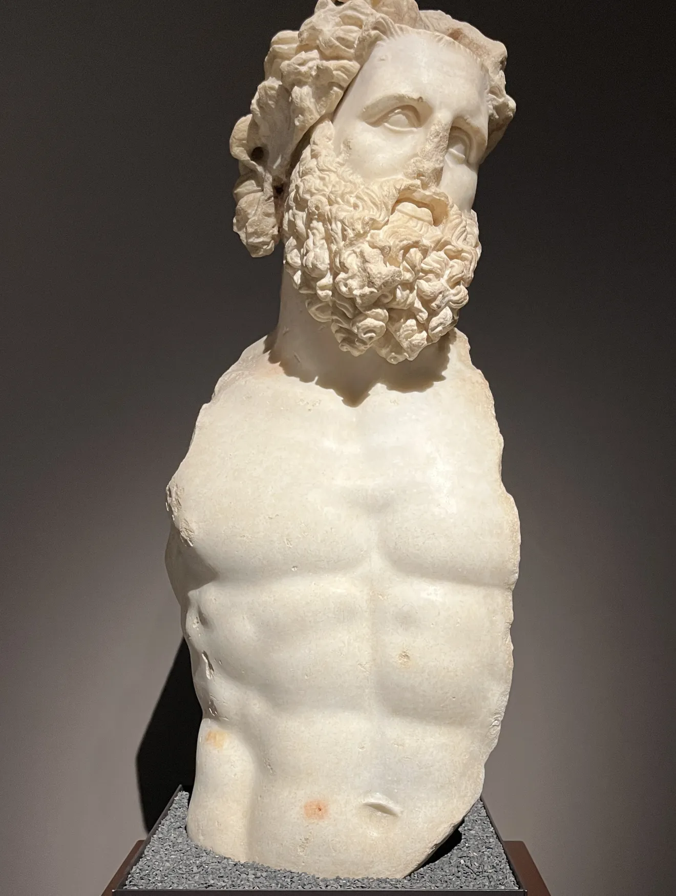 Bust of bearded figure. Arms are broken off.