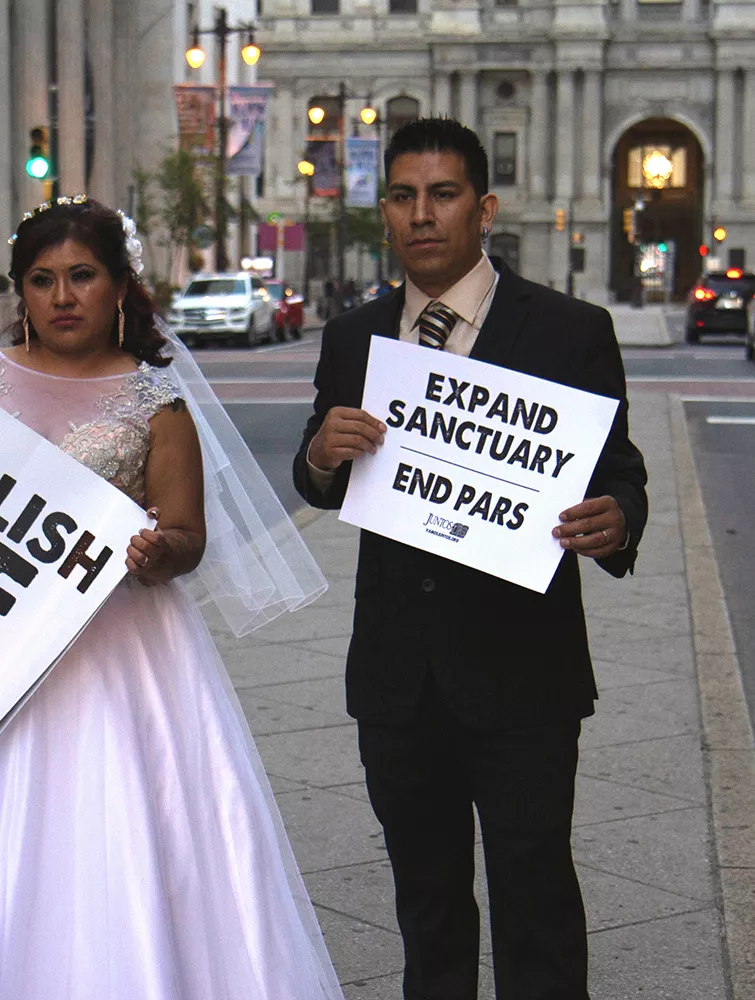 Protesters in wedding clothes