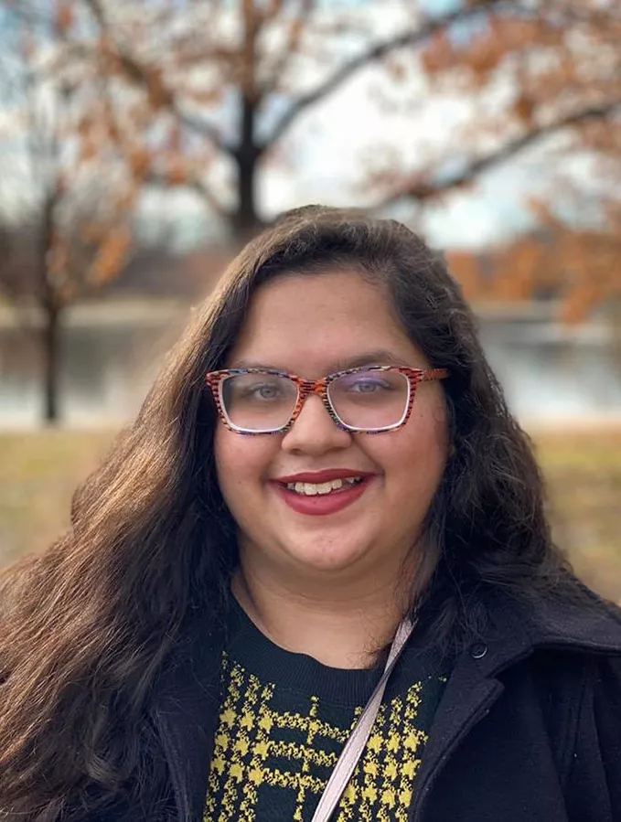 Mayisha Rahman in front of a lake.