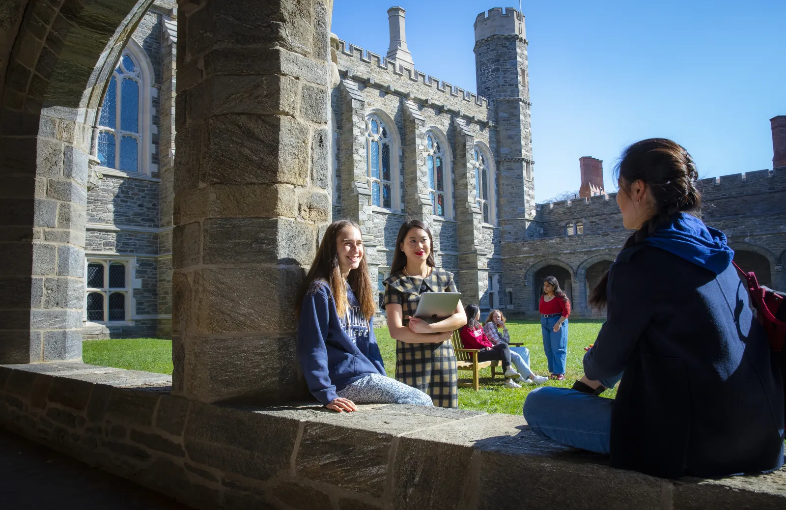 Students sitting and talking in the Cloisters