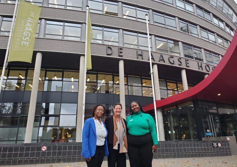 Alison Cook-Sahter, Khadijah Seay, and Ebony Graham standing in front of the Hague University in The Netherlands