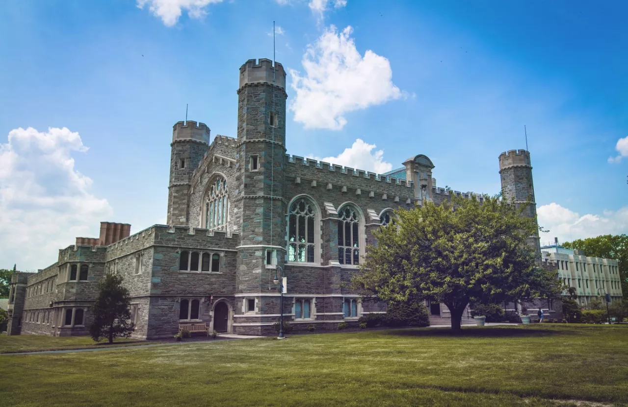 Large stone building with green grass