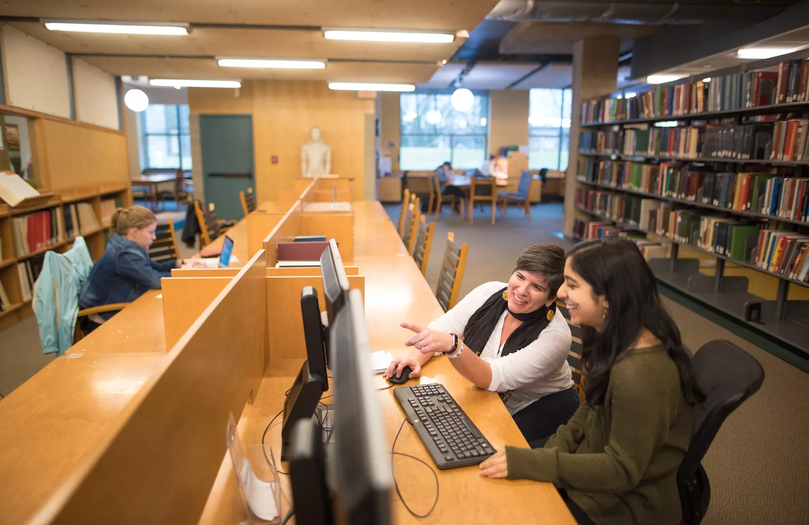 Two students looking at a computer monitor