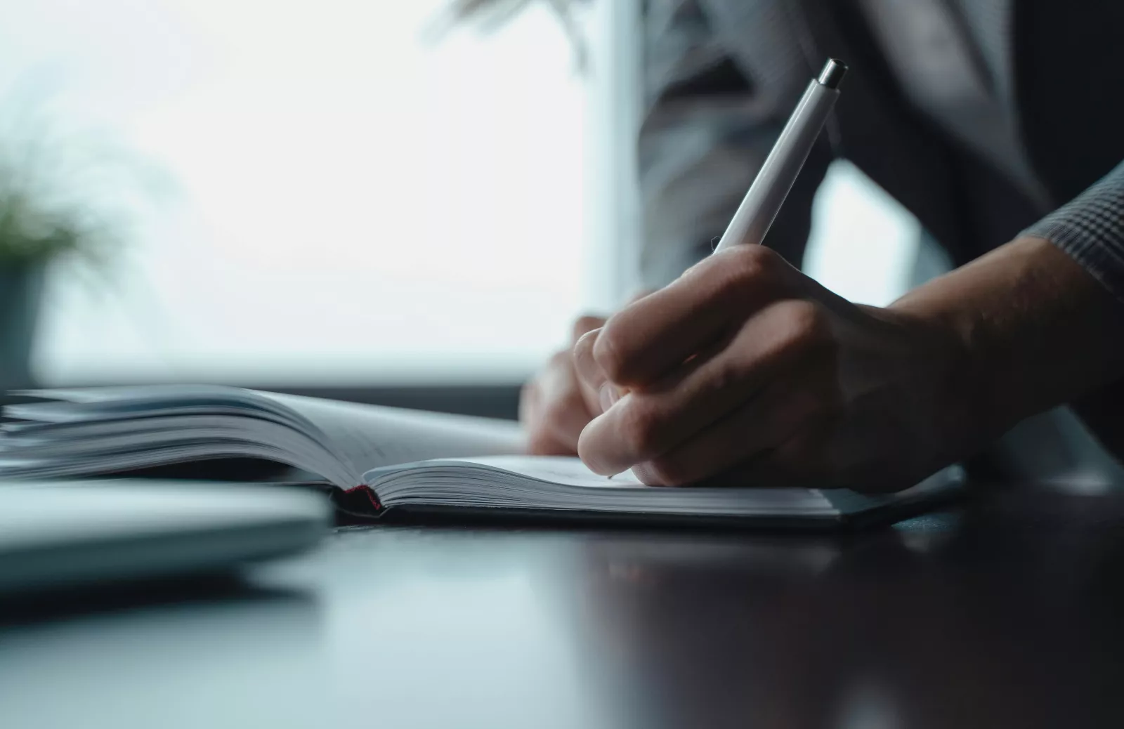 person writing in a book