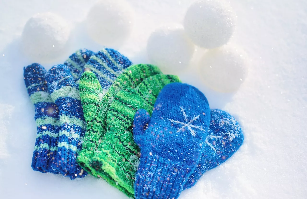 Mittens on snow with snowballs