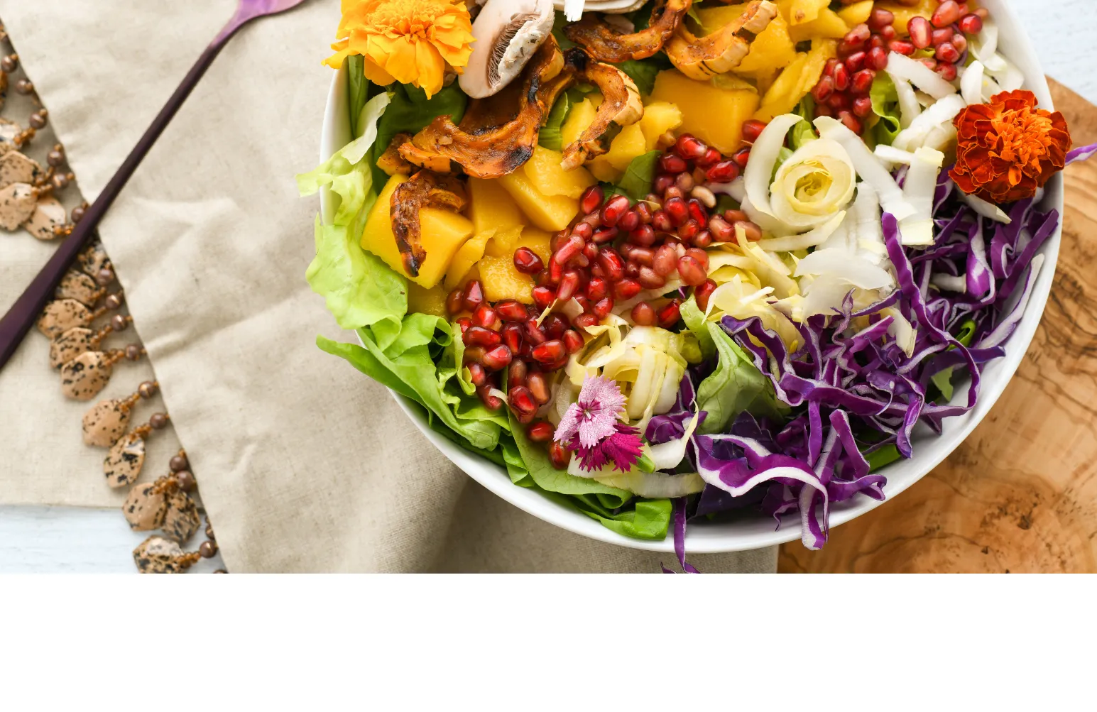 bowl of salad on a placemat with a fork