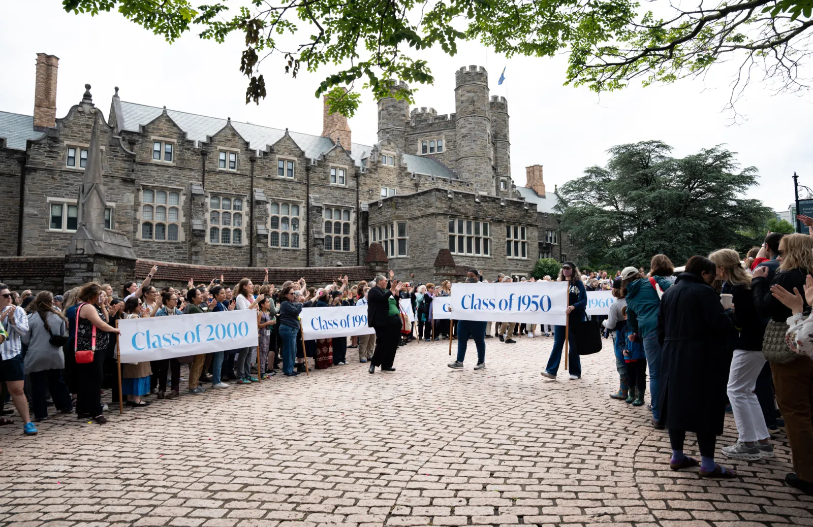 The classes proceed behind their banners into Goodhart during Parade.