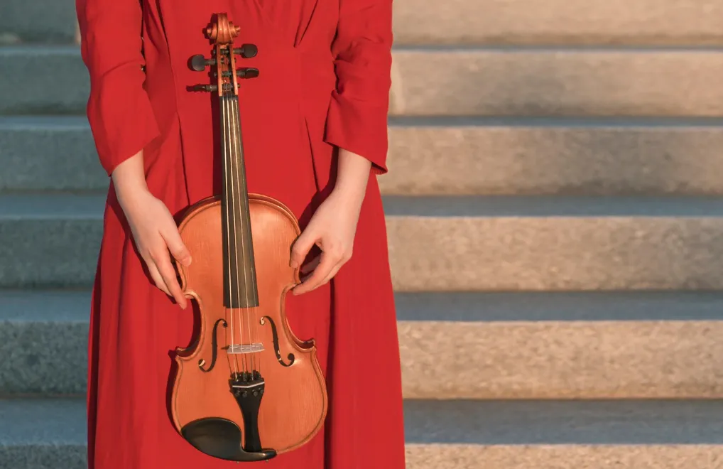 woman in red with violin stock