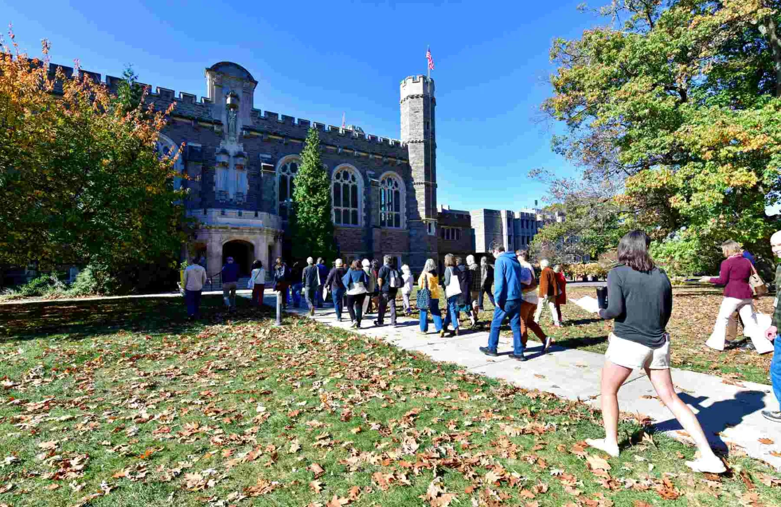 A group of students and family members walk towards Old Library