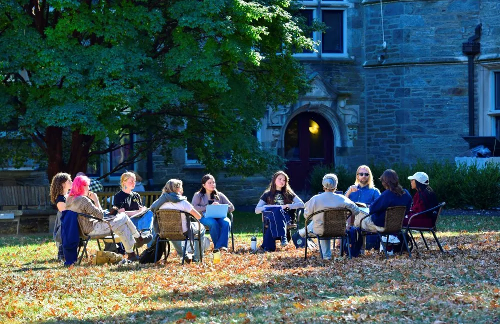 A group of adults of various ages sit in a circle.
