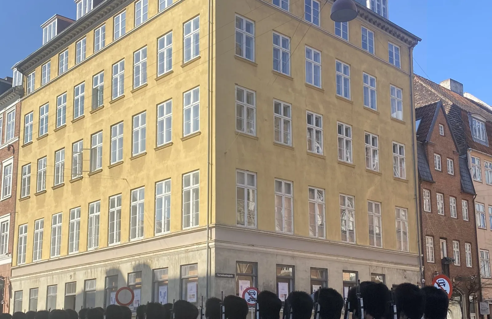 a parade of royal guards on a street in Copenhagen