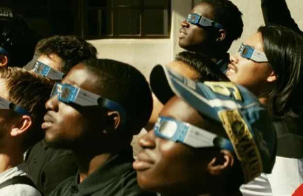 boys watching eclipse in special glasses