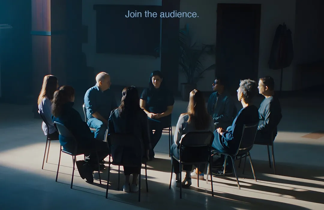 Film poster for We Are the Audience. A group of people sit in a chairs arranged in a circle.