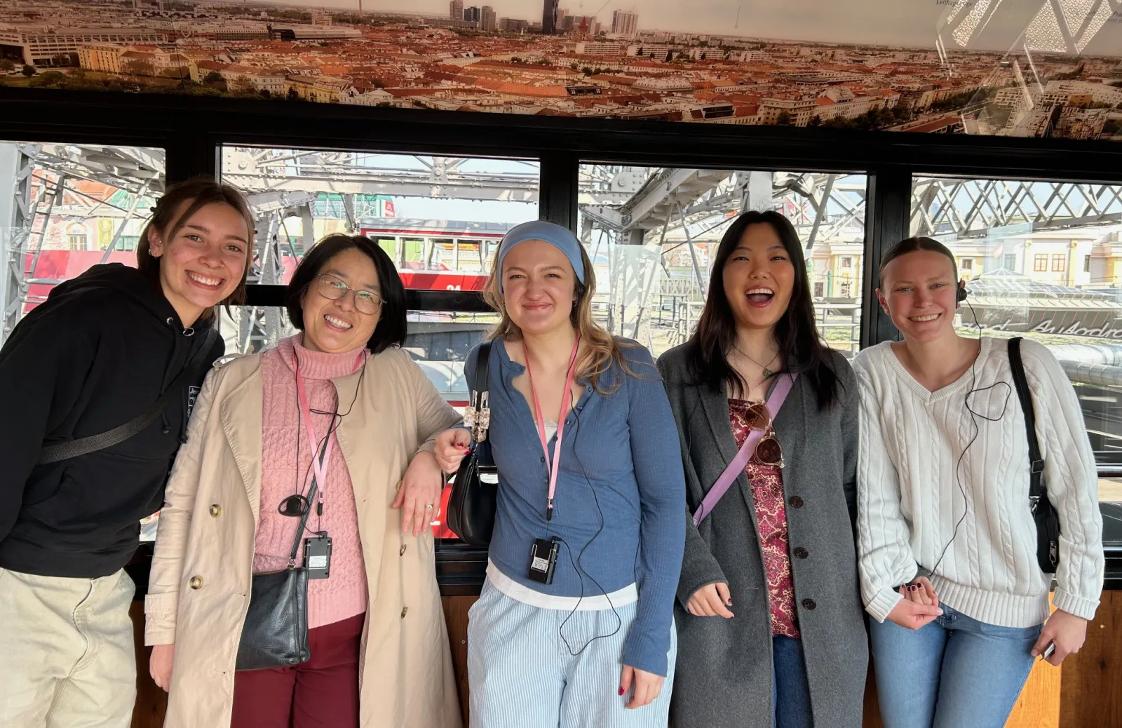 Bridget Barron ‘29, Professor Shen, Katja Wurm ‘28, Eliana Haah ‘26, and Lexi Mireider ‘28 smiling for a photo in one of the cars of the Giant Viennese Ferris Wheel.