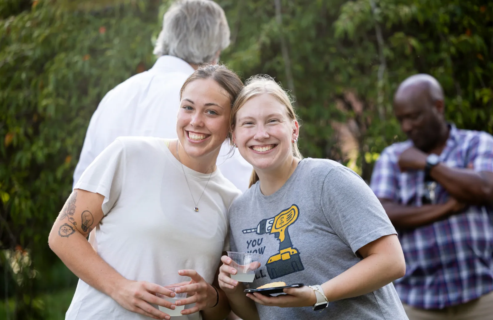 The women smiling and holding cups 