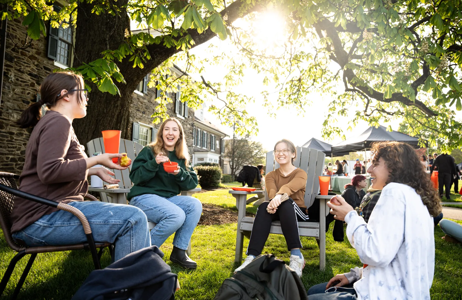 Bryn Mawr College students enjoying outdoor campus dining and conversation.