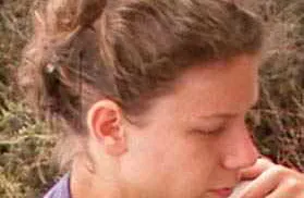 Profile of woman looking down.