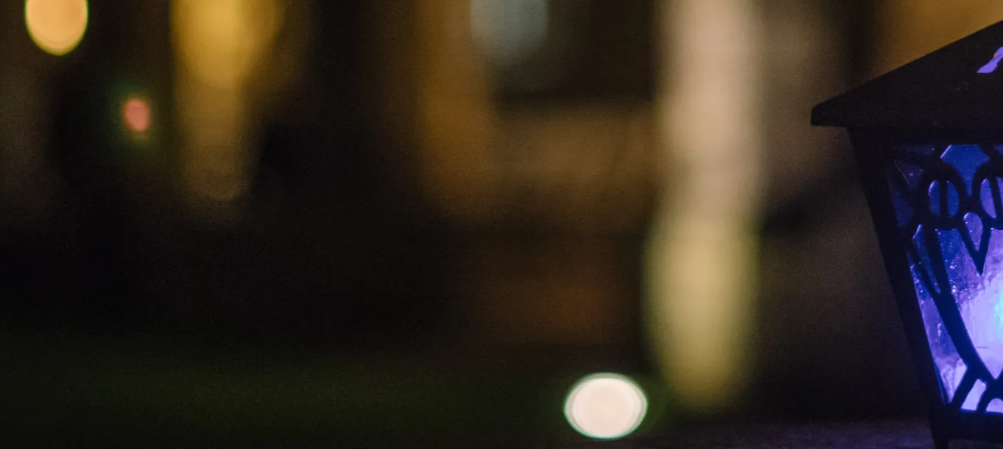 A photo of a dark blue lantern aglow.