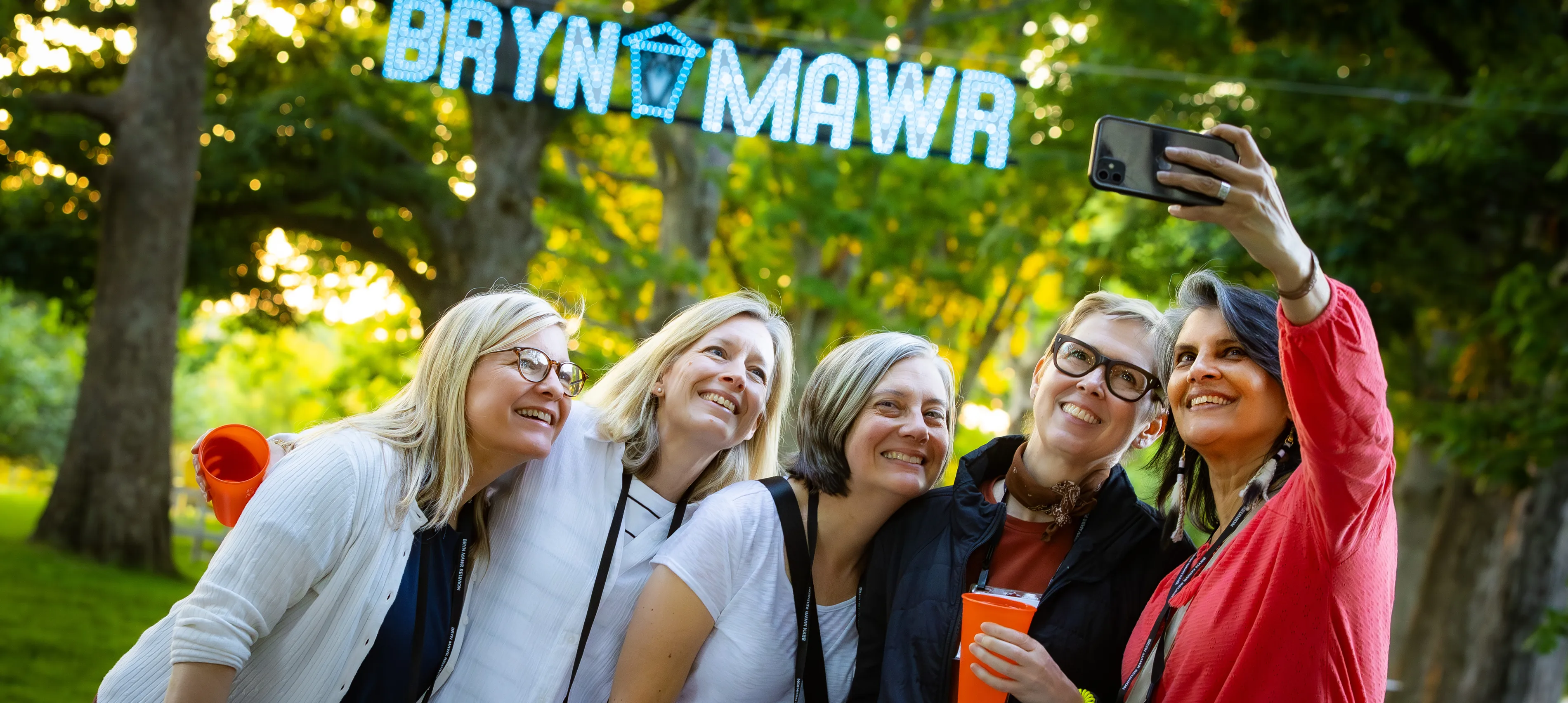 Alums taking selfie in front of Bryn Mawr sign