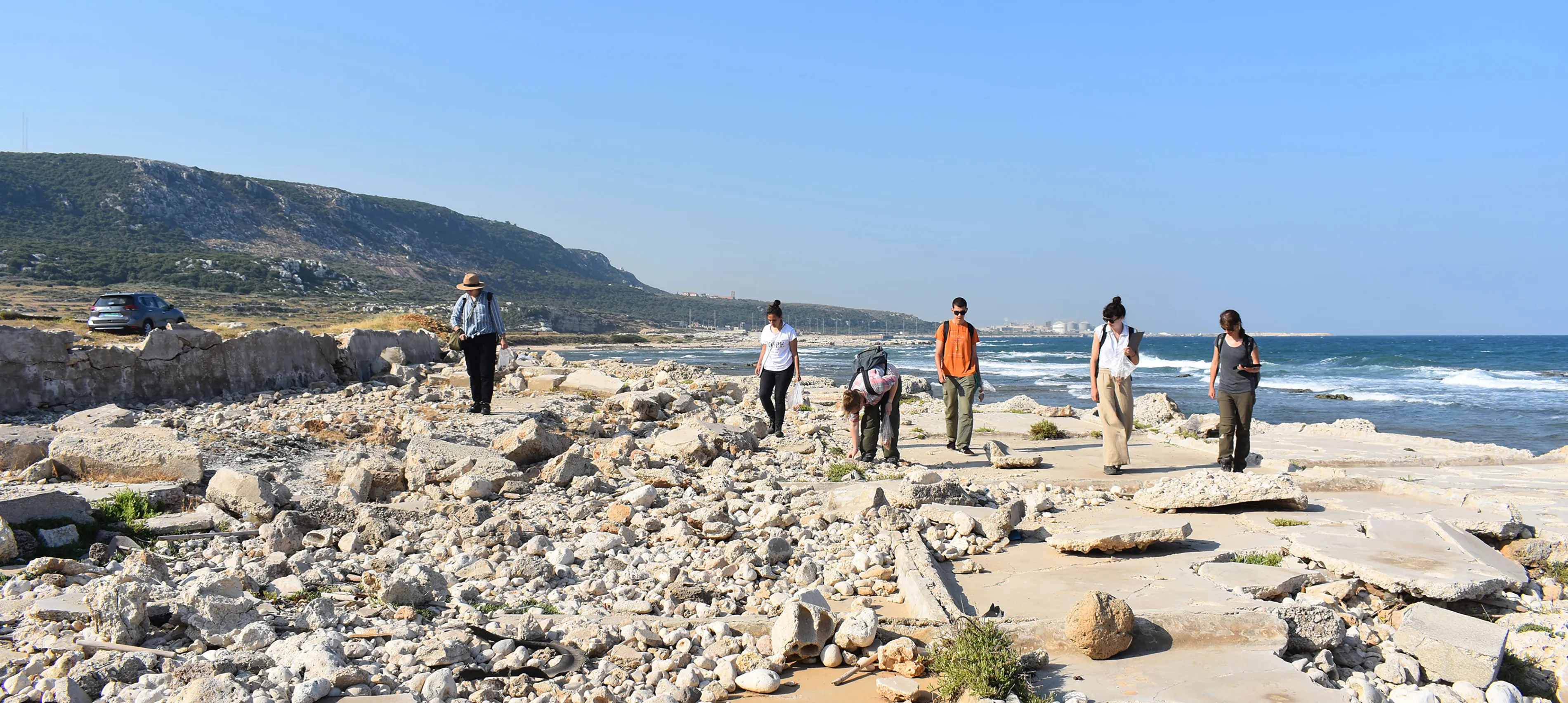 Classical and near eastern Archaeology students walking in sun bleached ruins