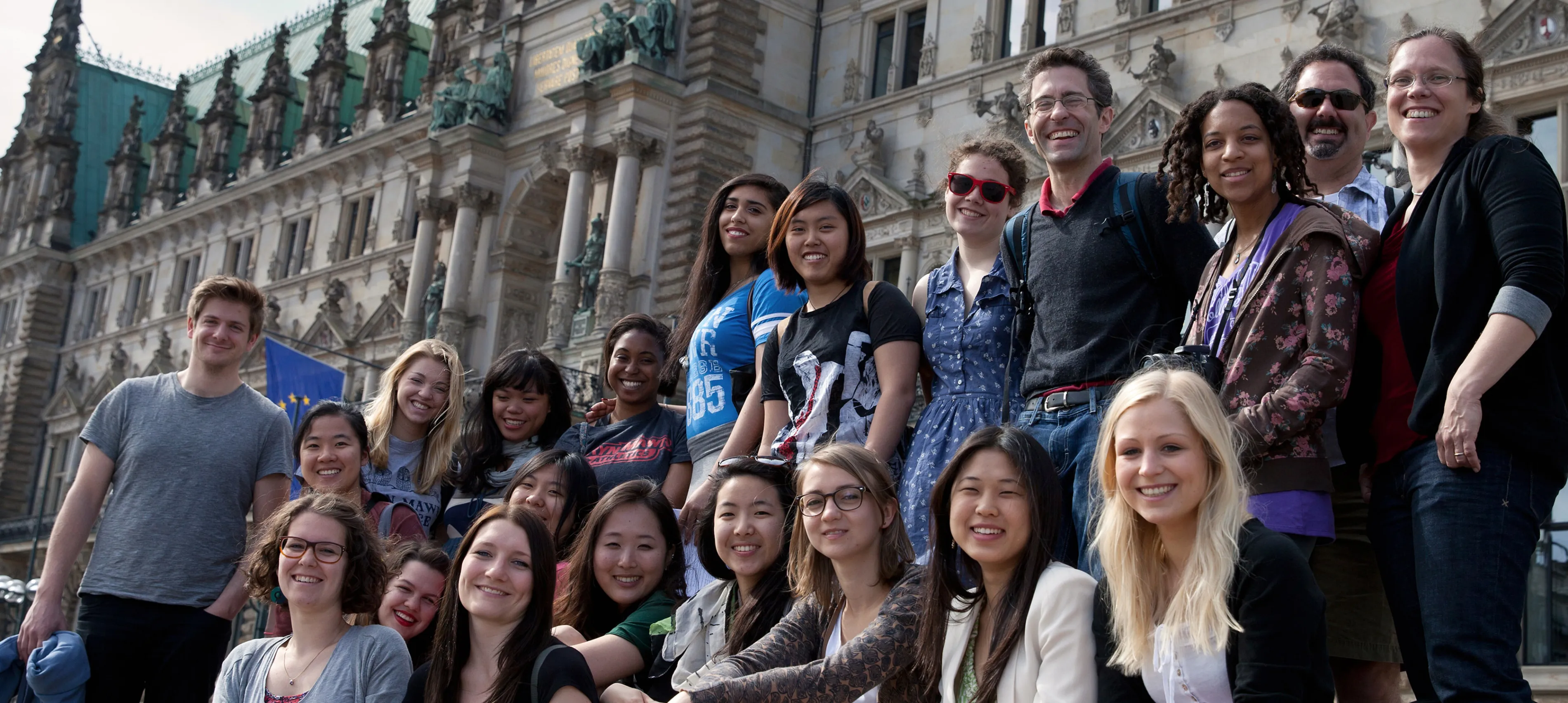 A group of Bryn Mawr and Haverford German Studies students and professors pose in front of a castle in Germany
