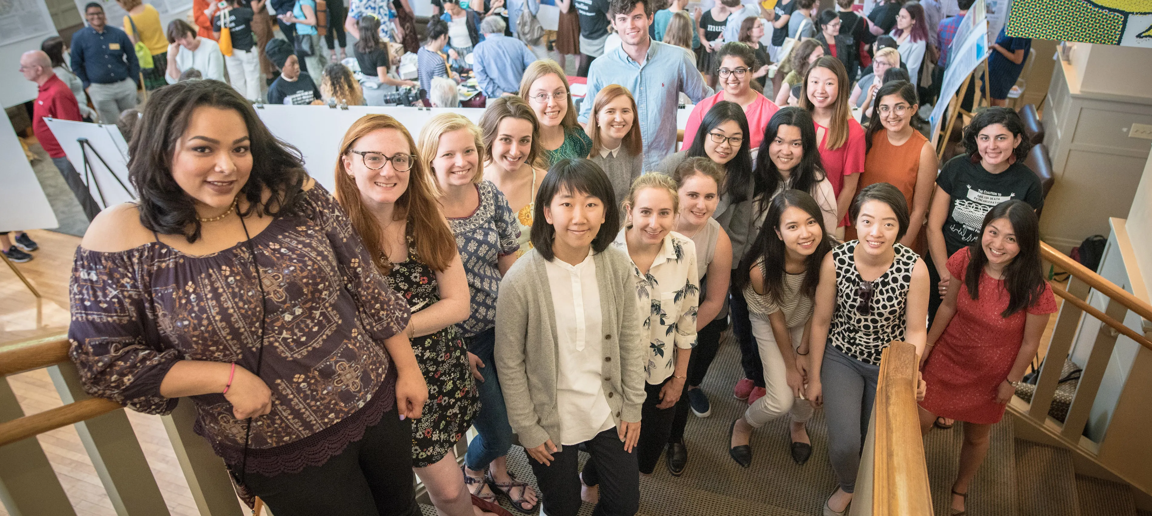 Bryn Mawr College Praxis students pose on a staircase while presenting their work