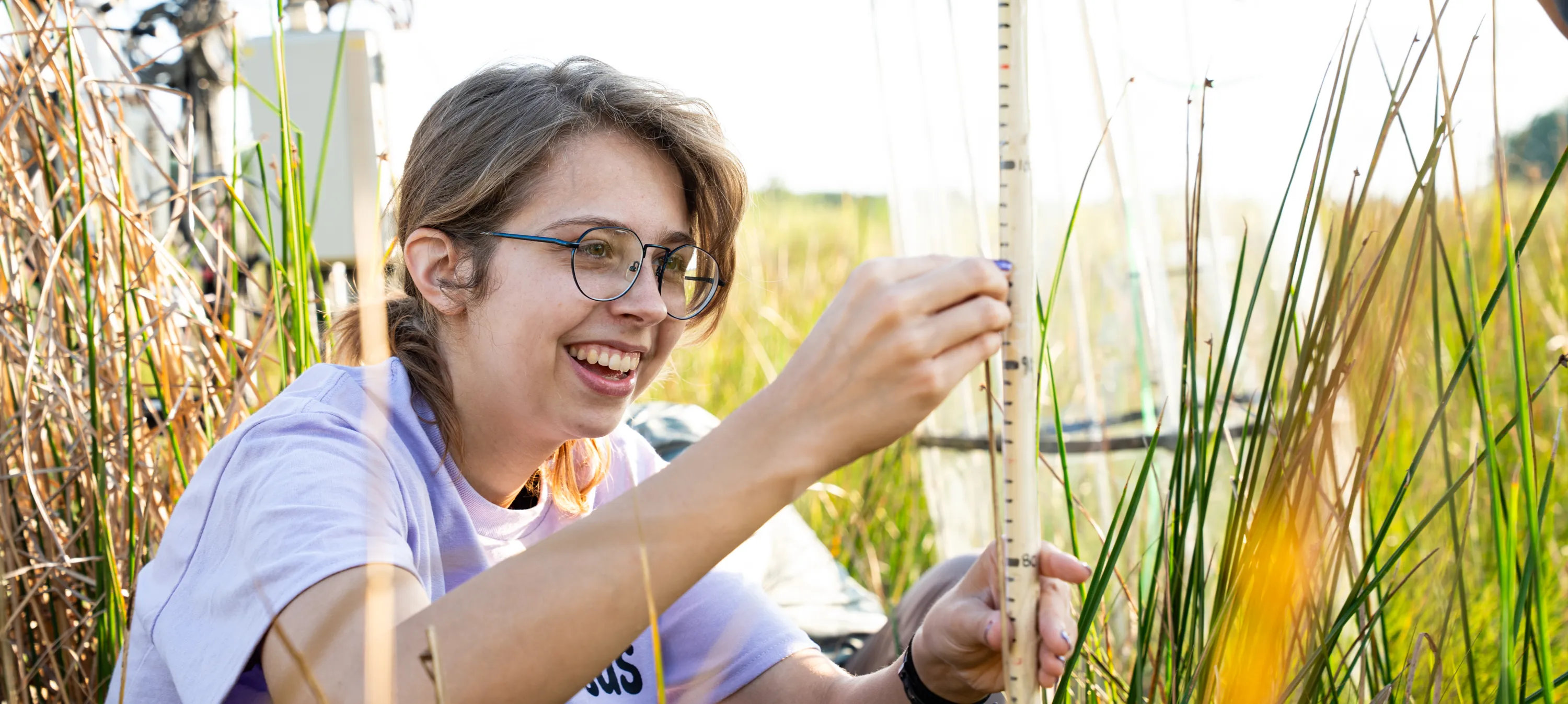 Carlson taking a measurement in a field