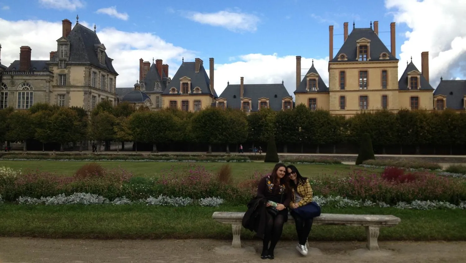 Bryn Mawr students abroad sit in front of a French chateau