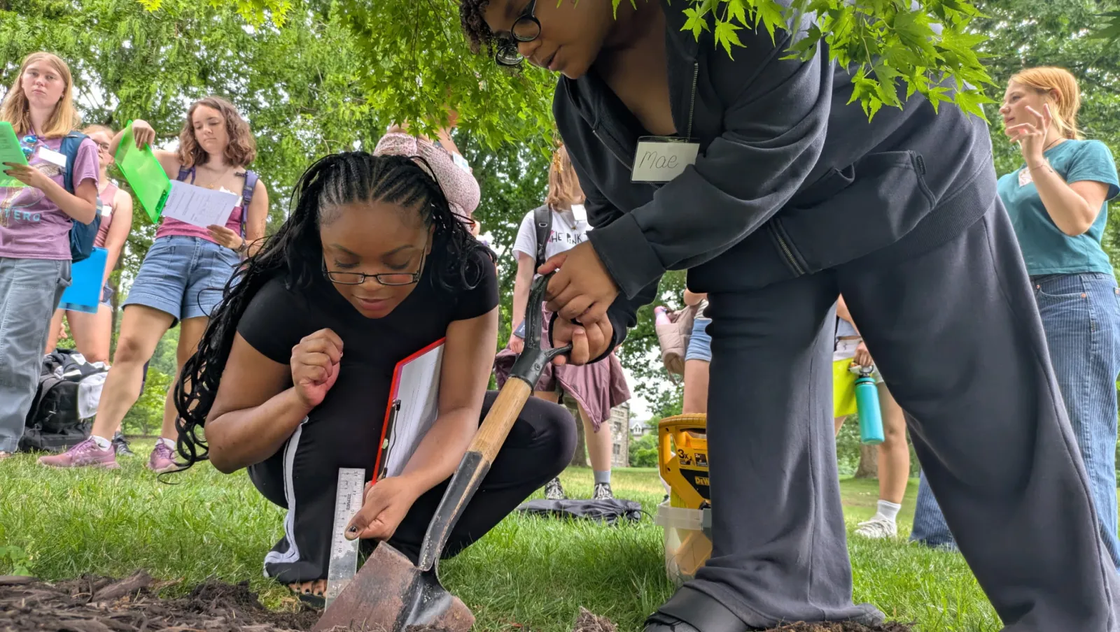 Eve and Mae take soil samples on campus 