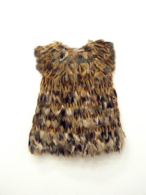 Miniature dress made from feathers.