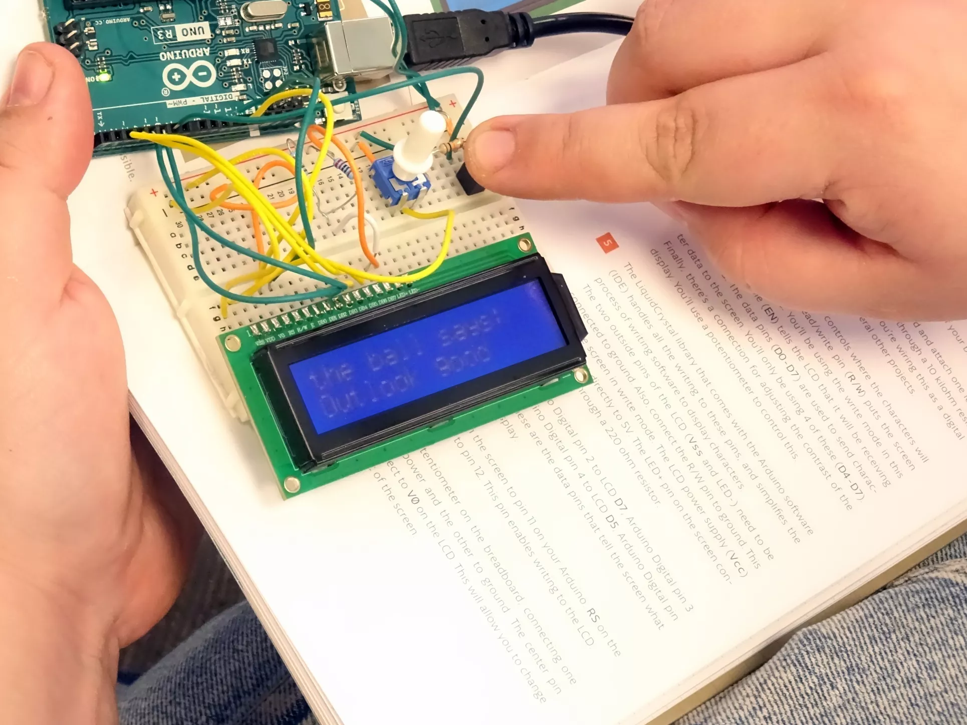 A student test their fortune telling device during the physical computing intensive
