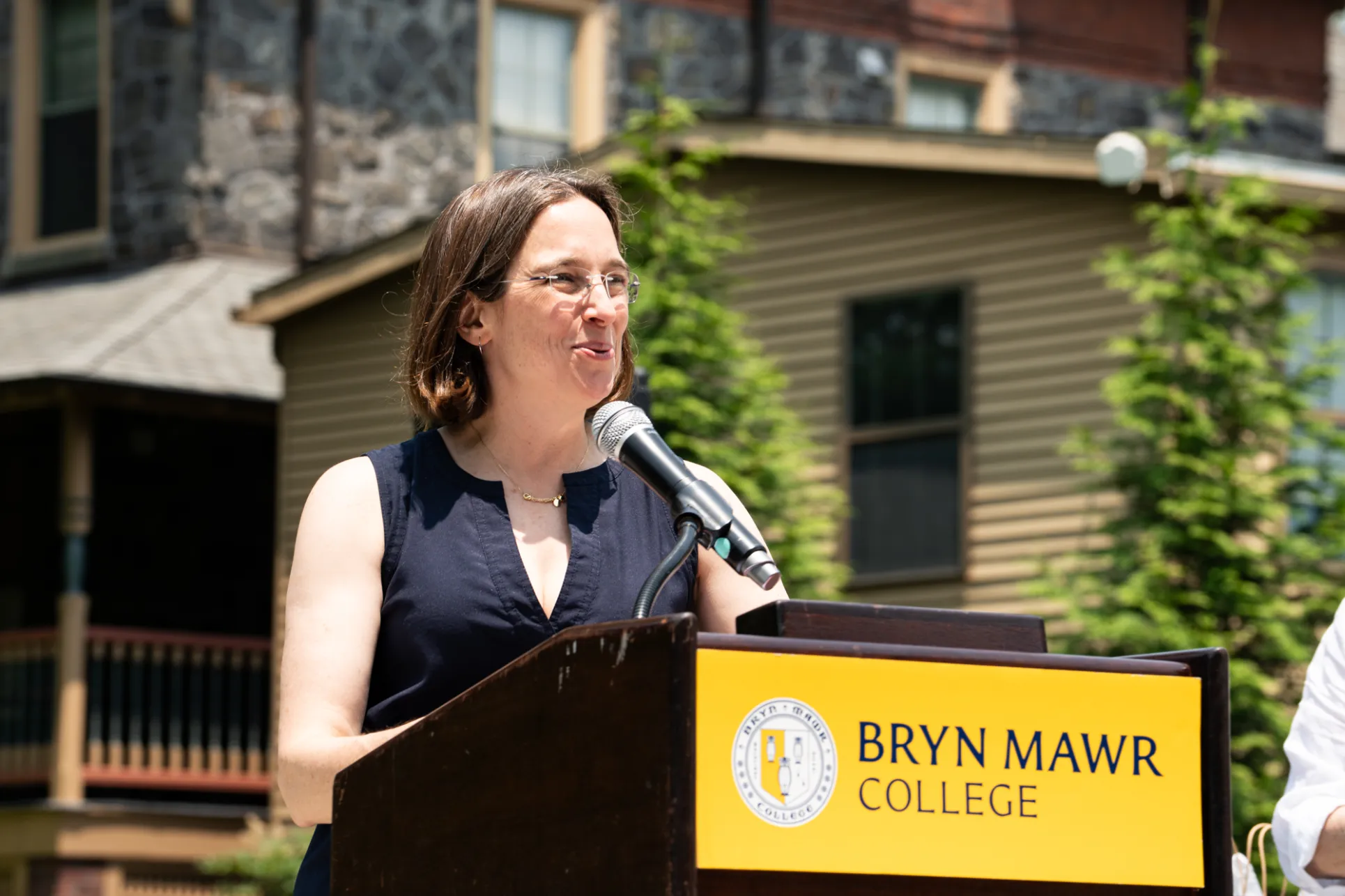 Wendy speaking at the podium at the staff picnic
