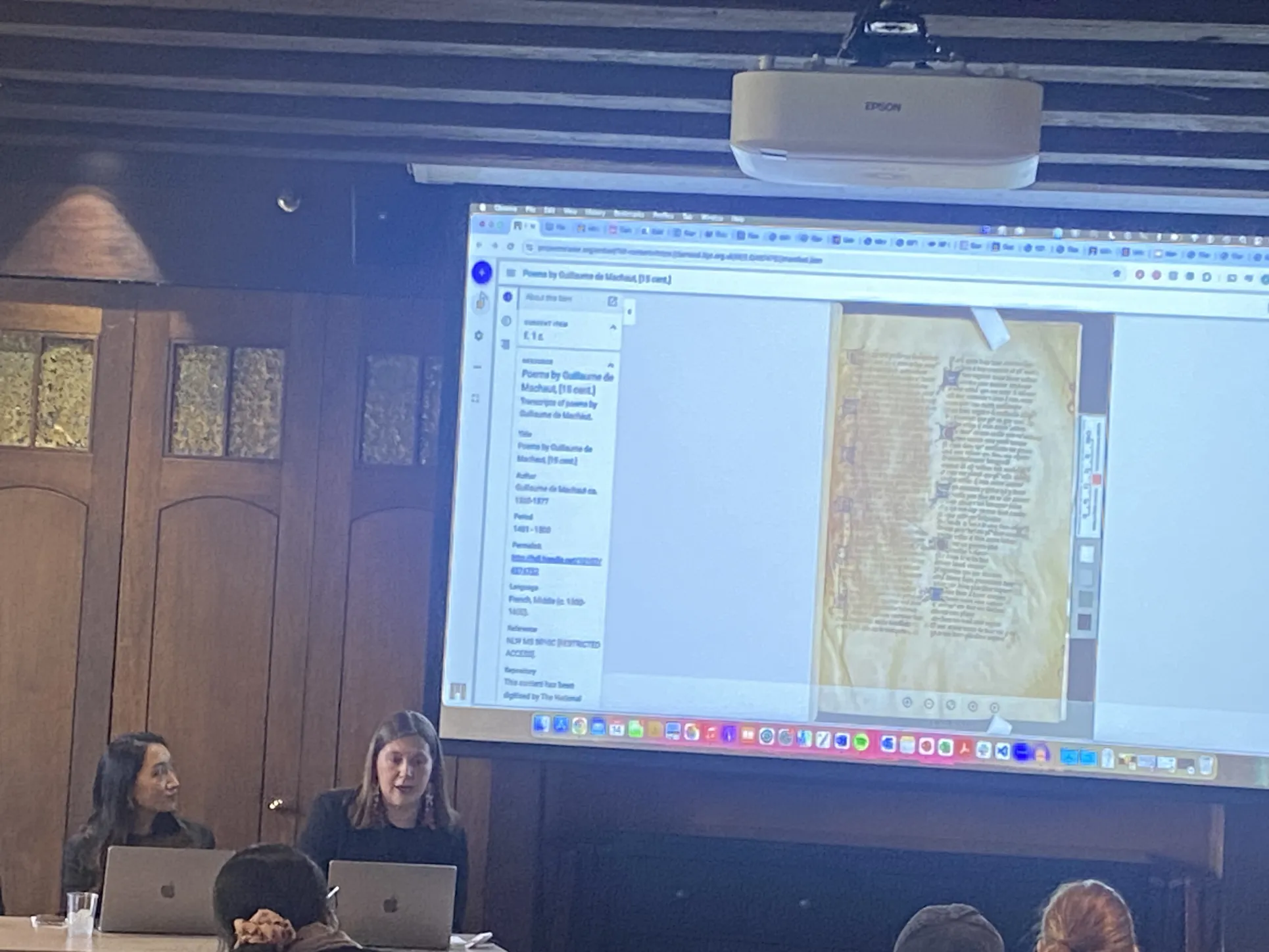 Hilde Nelson discusses standards for formatting annotations on art pieces. A manuscript is on the projector screen behind her.