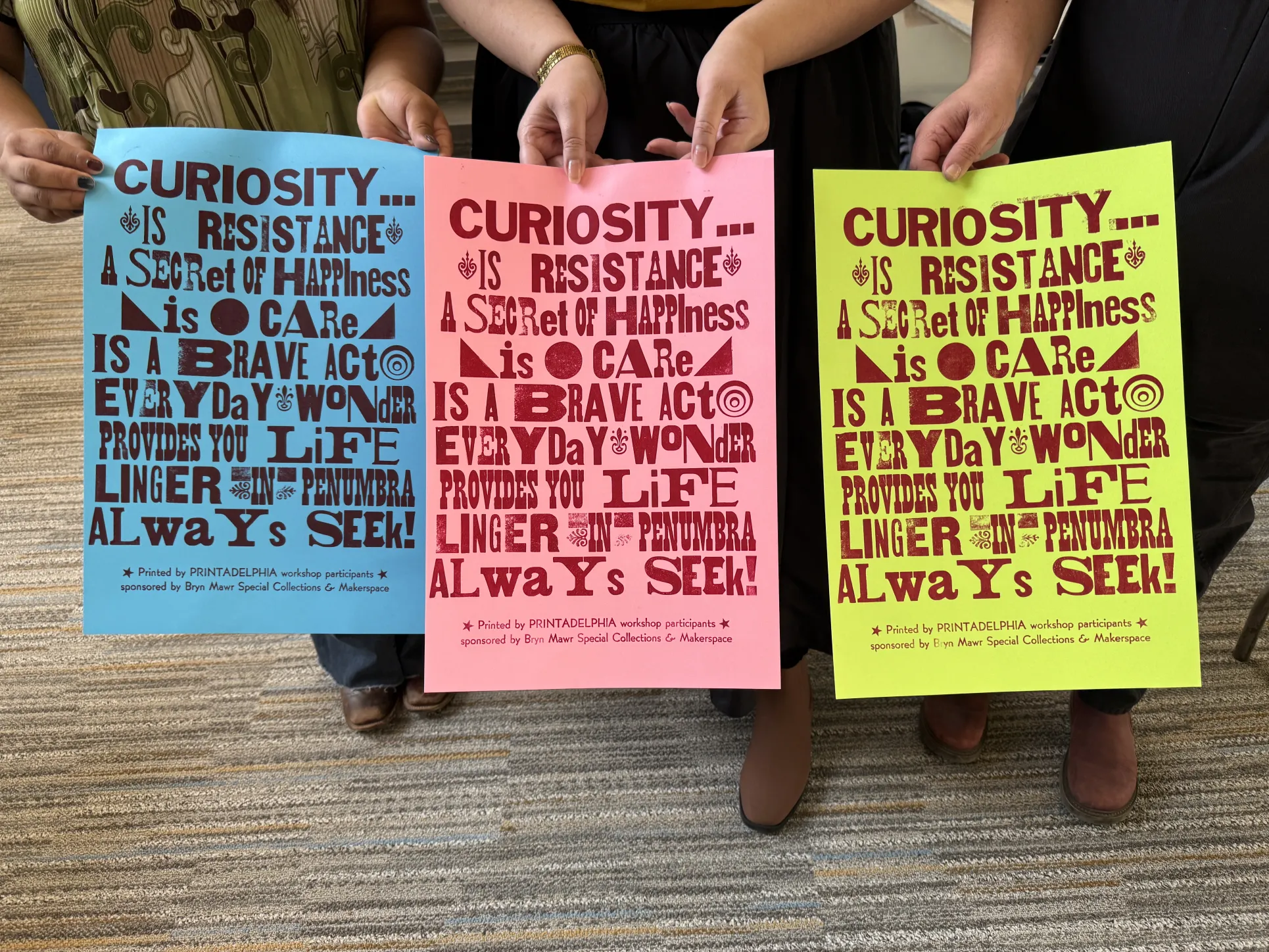 Poster about Curiosity printed on blue, pink, and yellow papers