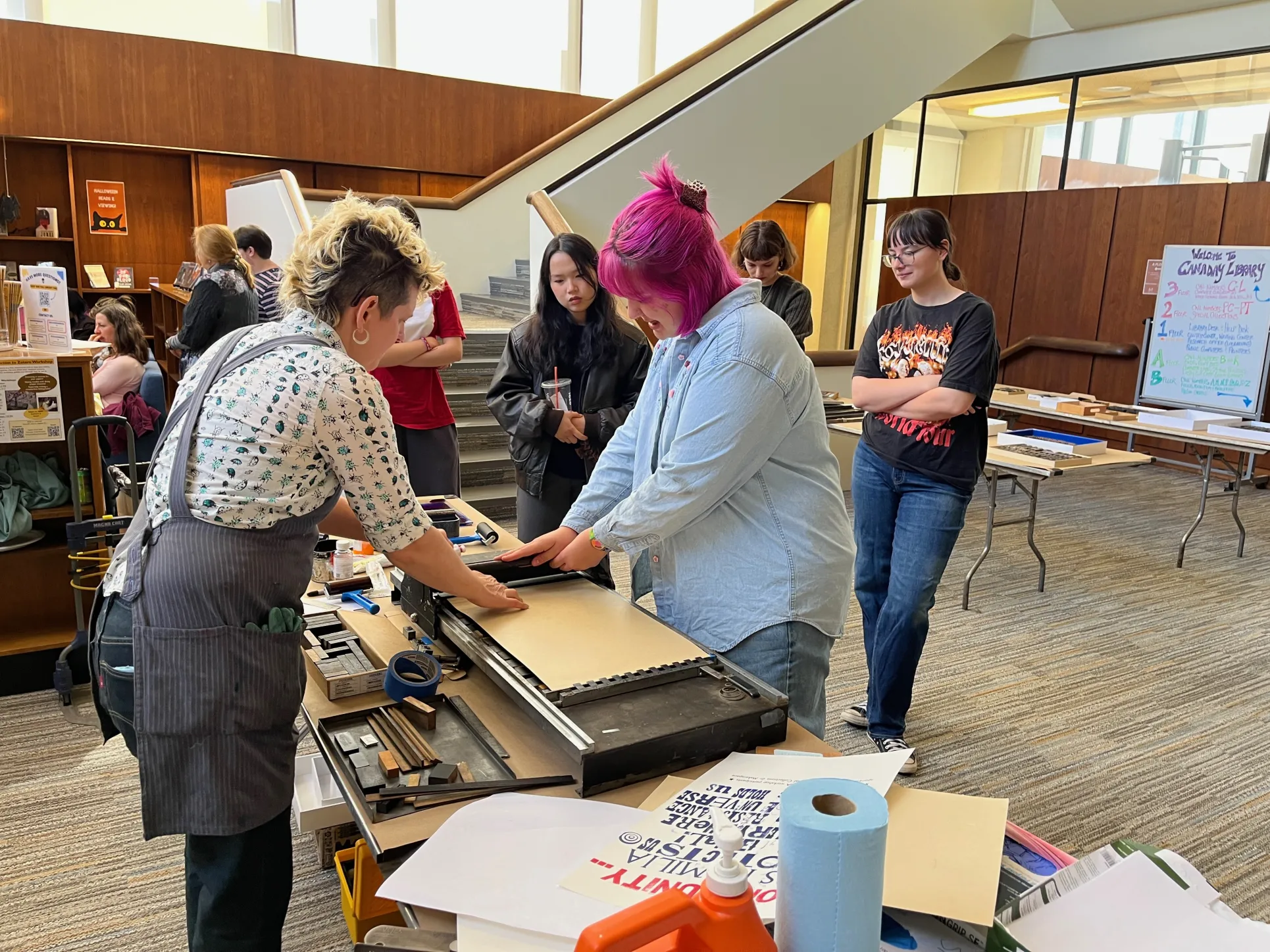 Student pulls poster from letterpress