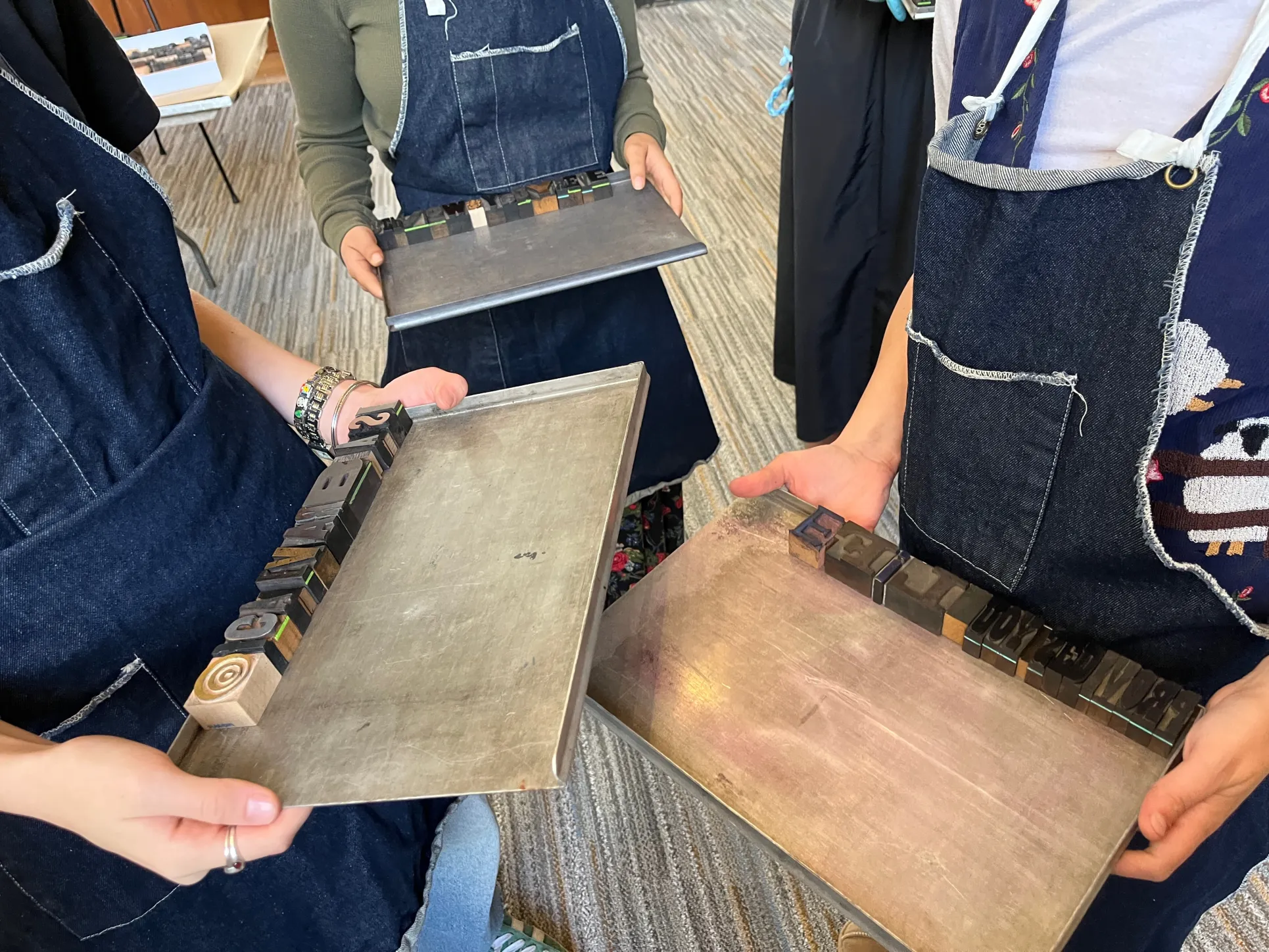 Students ready with trays laid out with their letterpress block message
