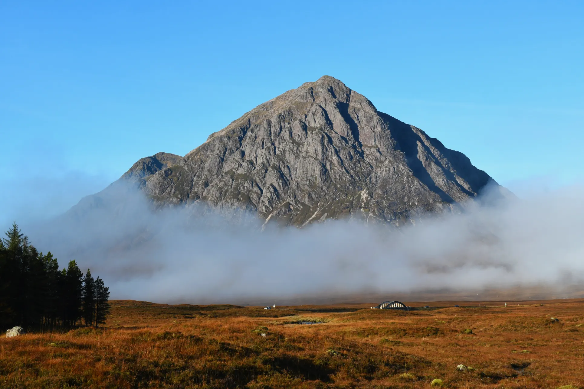 an image of a mountain in Scotland rising out of a cloud of mist