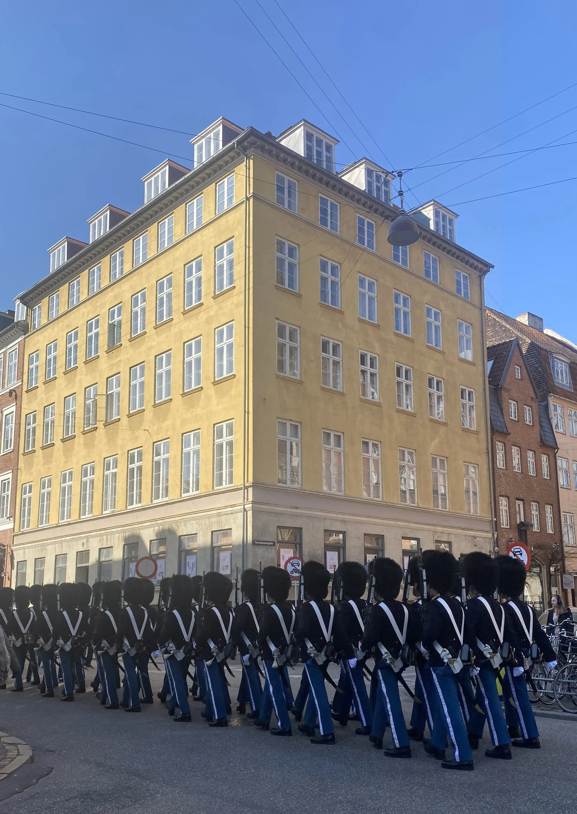 a parade of royal guards on a street in Copenhagen