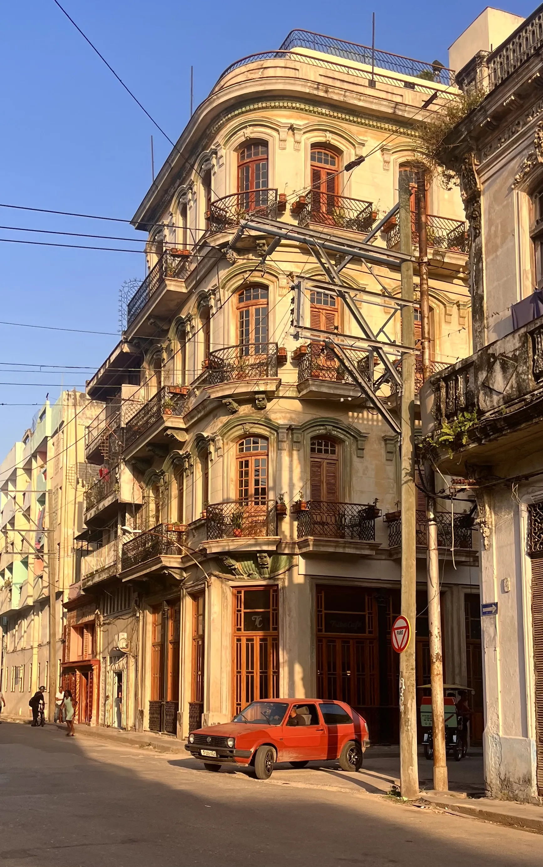 a golden hour image of an older car in downtown Havana, Cuba