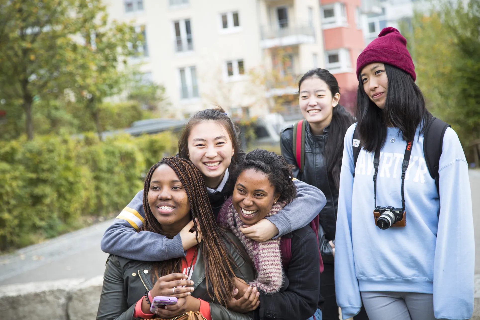 A group of environmental studies students hug and smile in Germany's green city