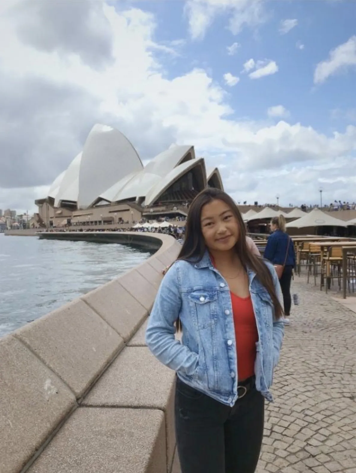 A Bryn Mawr College student abroad stands in from of the Sydney Opera House