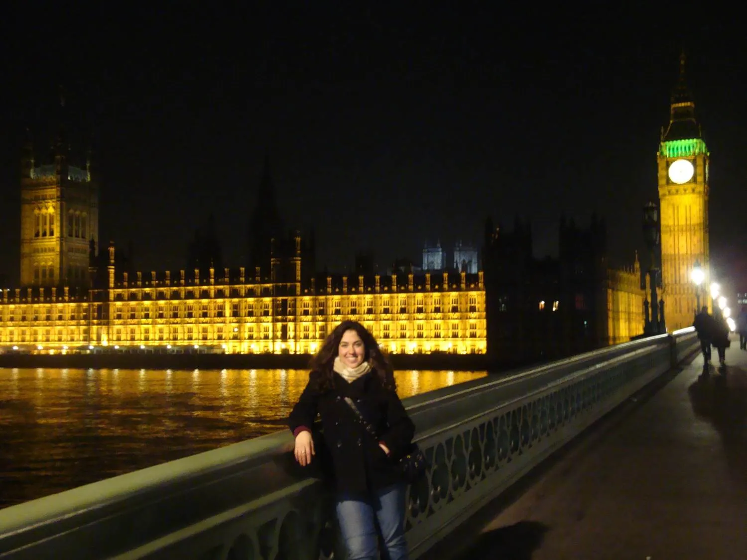 A Bryn Mawr College students poses in front of Westminster Castle at night
