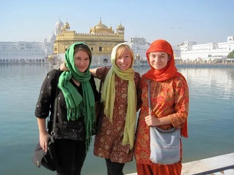 Three Bryn Mawr College students post across the water from the Golden Temple 