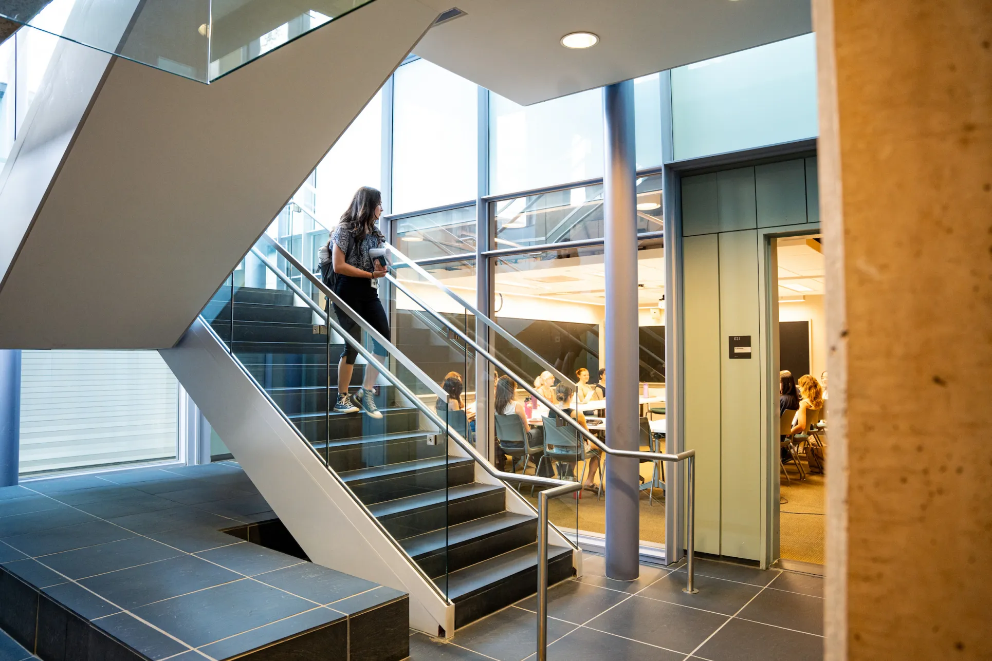 a student walking down the stairs to a classroom