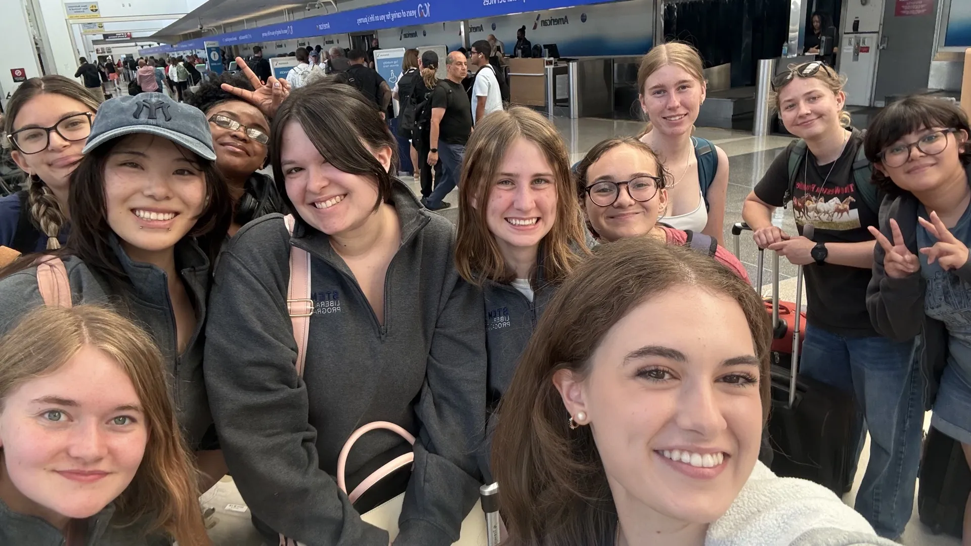 Fellows take selfie during departures from STEMLA summer program