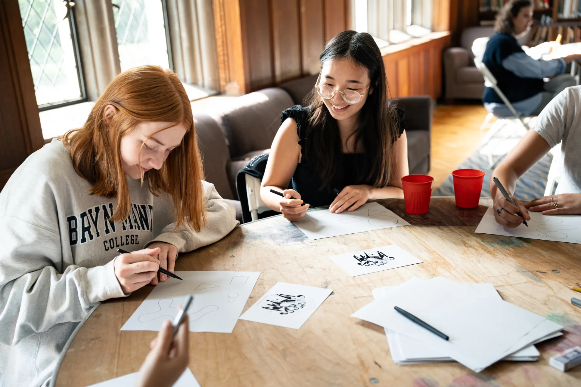 Students work on their single-panel cartoons at the Cartoon Workshop. Photo by Caroline BIttenbender.