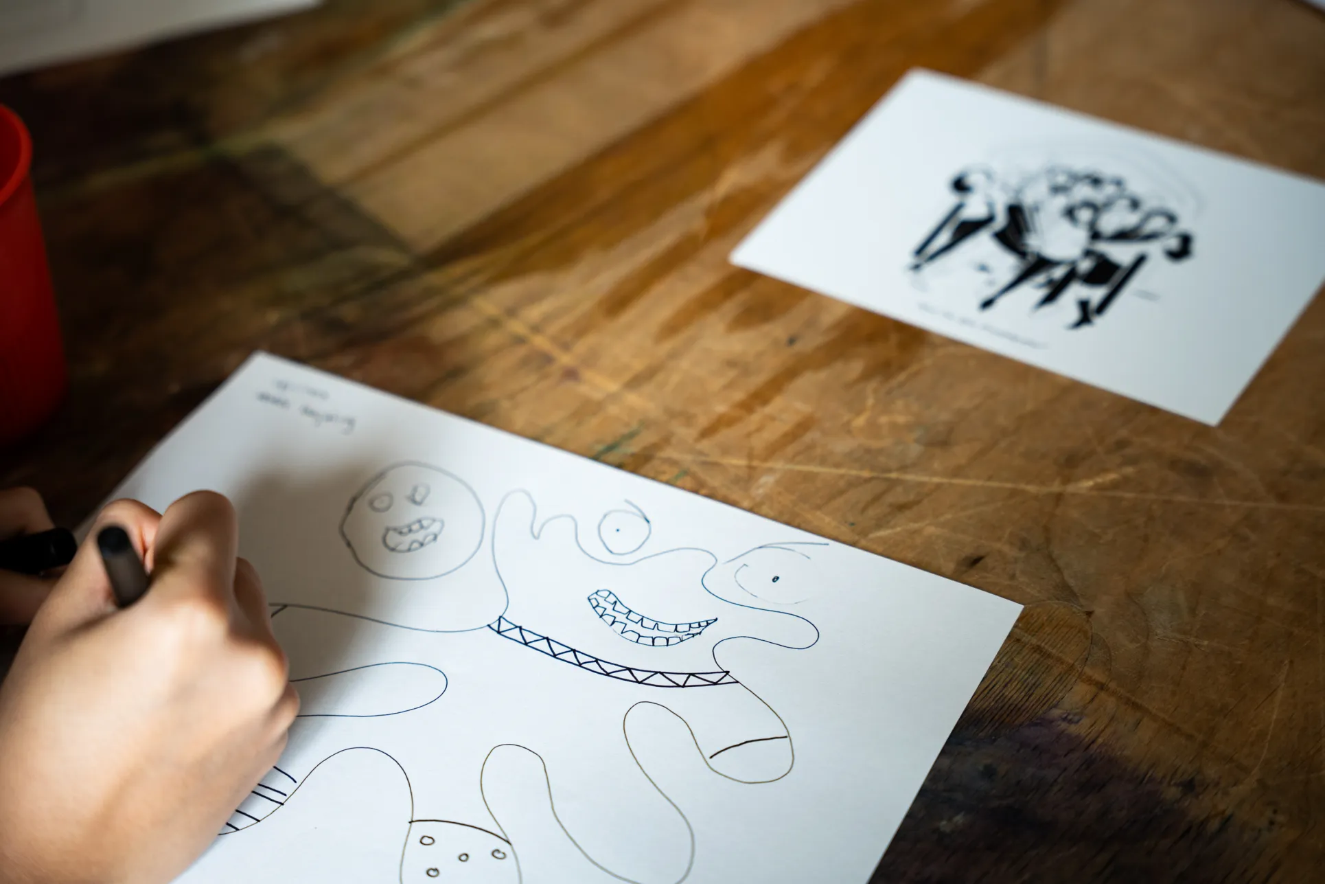 A student draws at the Cartoon Workshop. Photo by Caroline Bittenbender.