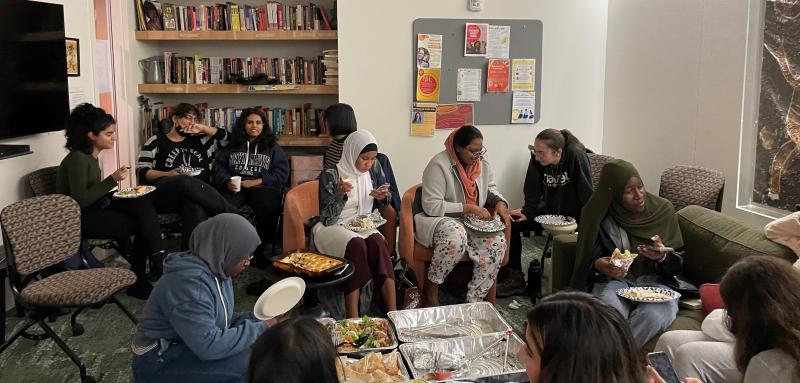 Students enjoying halal food in the Multicultural living room at The Well