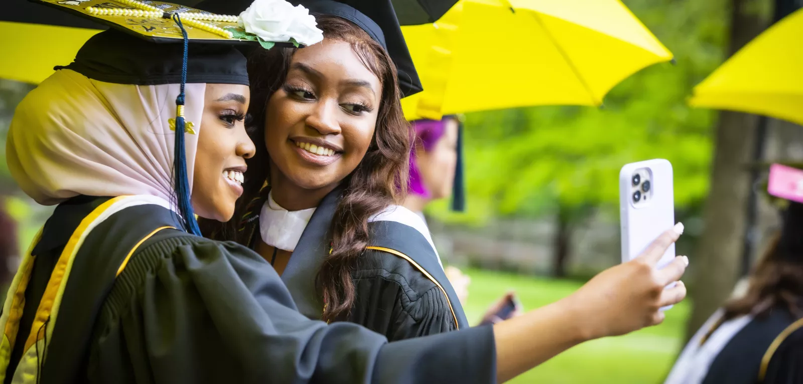 Students taking a selfie at graduation